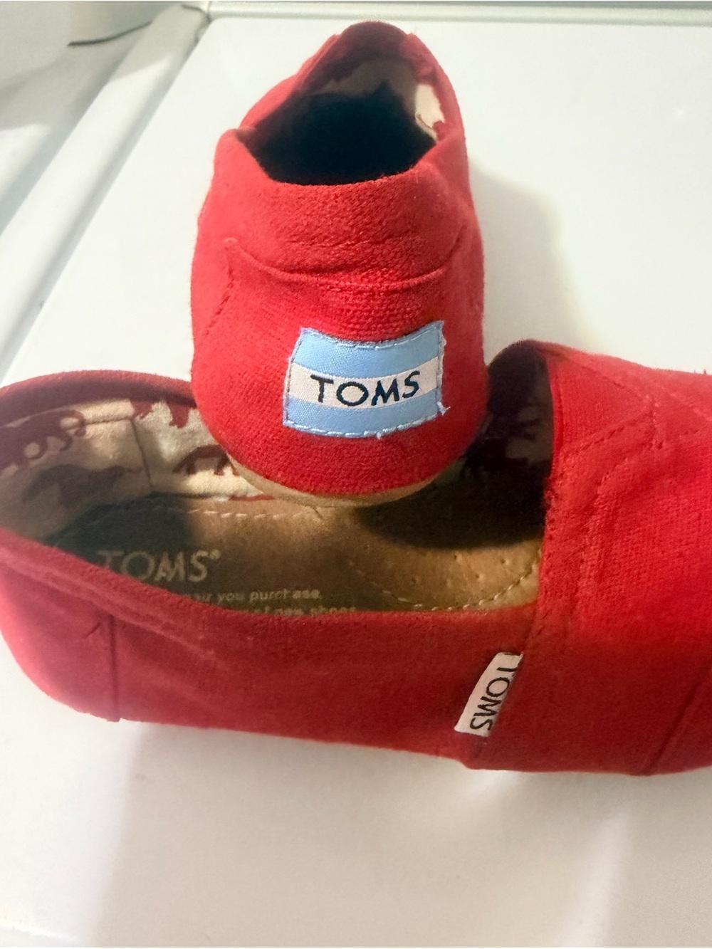 TOMS Red Canvas Slip-On Shoes with Blue Logo Patch